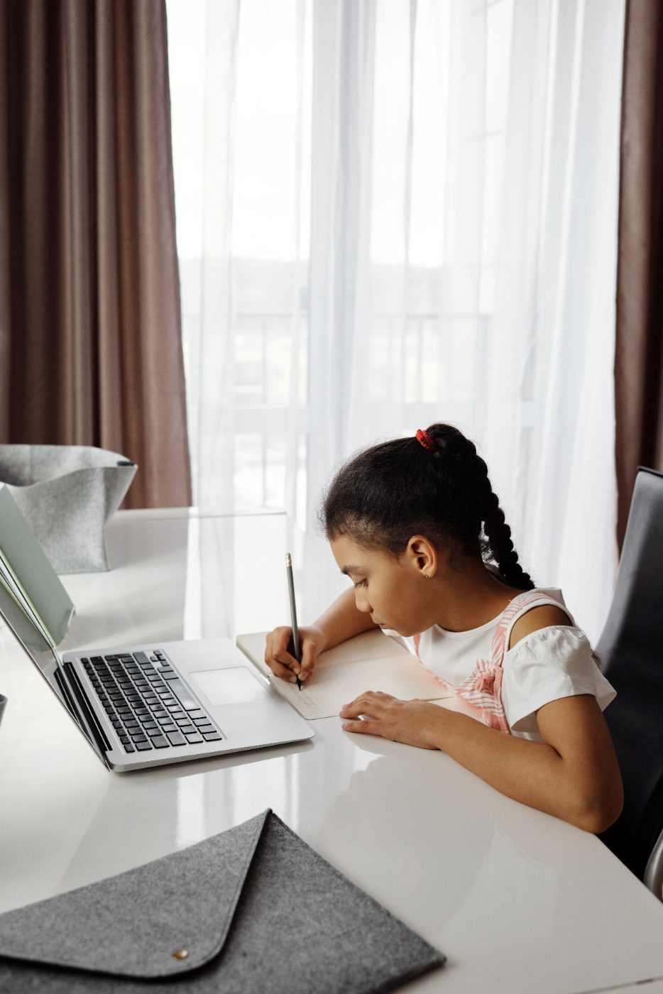 A child learning with their tutor over video call
